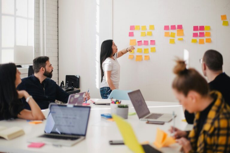 Entrepreneur leading a startup team discussion in a modern office.
